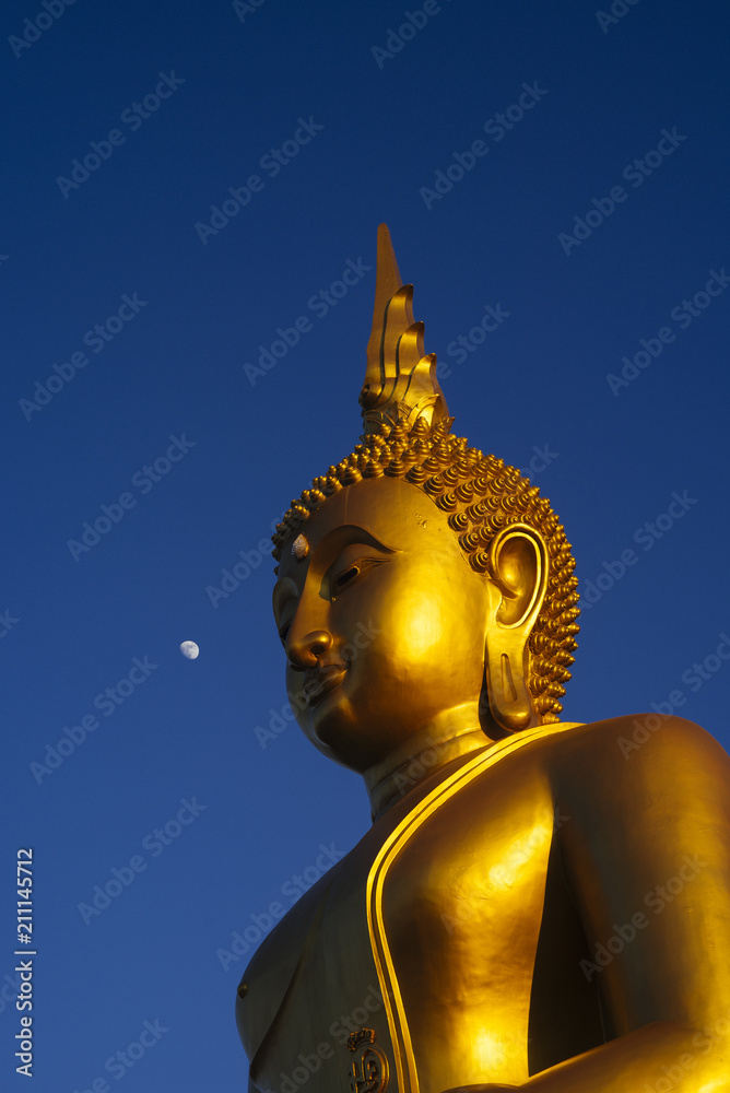 Buddha statue with moon and blue sky