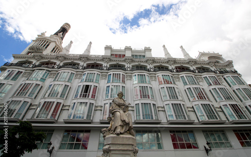 Beautiful white building and statue on Saint Anne Square (Plaza de Santa Ana) located in the old town of Madrid, Spain, Europe. Spanish landmarks and architectural backgrounds. photo