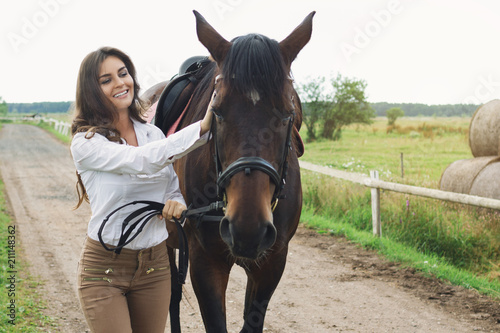 Young woman rider and her beautiful horse