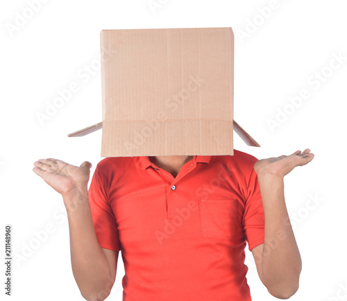 Young man gesturing with a cardboard box on his head isolated on white background