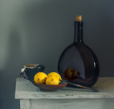 Still life with lemons and a bottle. Etude. Minimalism. Vintage.