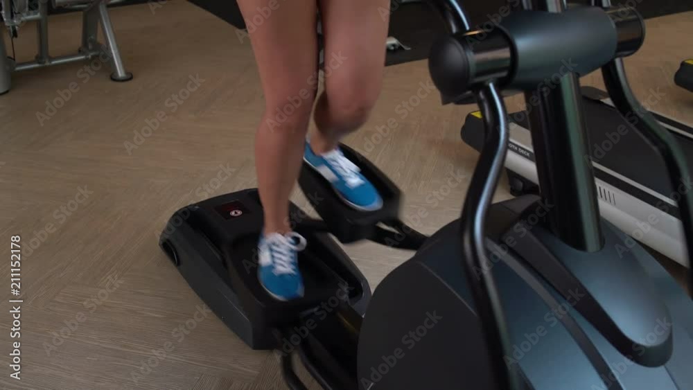 In the gym women's legs at kardiotrenazhere In the gym women's legs at kardiotrenazhere