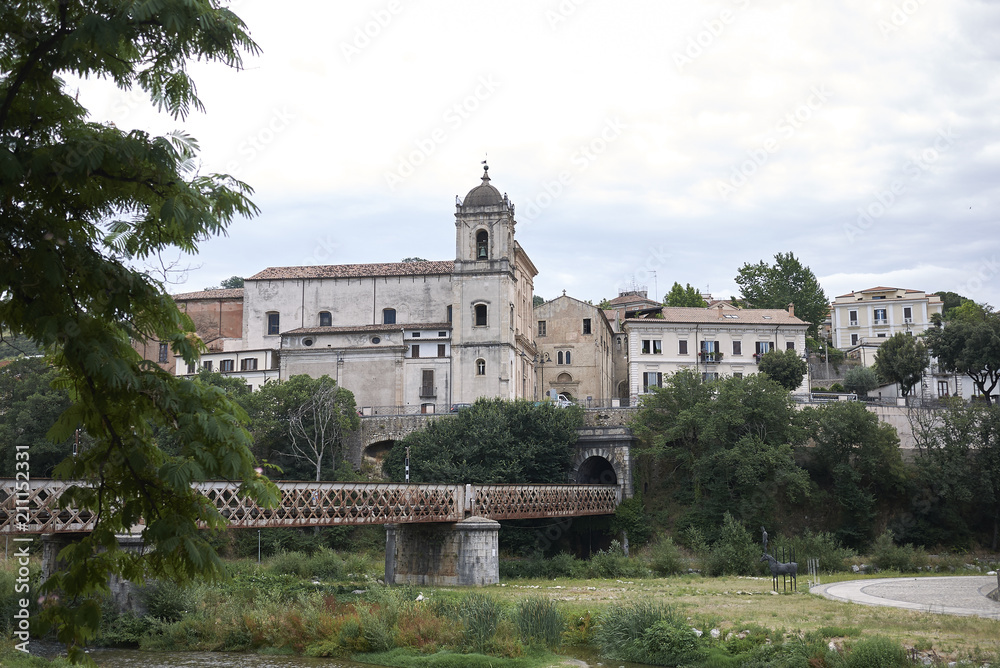 Cosenza, Italy - June 13, 2018 : View of the railway bridge and San Domenico church in the background