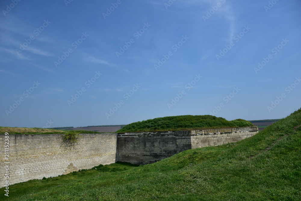 old stone fortress and green lawn