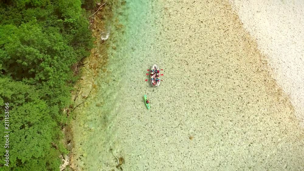 Aerial view of a group of people doing rafting turquoise and transparent water. Aerial view of a group of people doing rafting turquoise and transparent water.