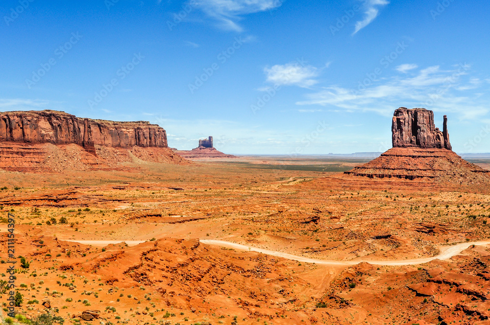 A Gravel Road Passes Through the Desert of Monument Valley