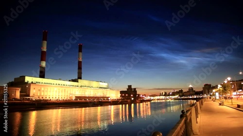 Noctilucent clouds in Moscow. Building and pipes of the combined heat and power plant.