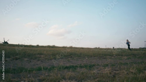 Wallpaper Mural Runner woman running in park exercising outdoors fitness tracker wearable technology. Jogging at sunset Torontodigital.ca