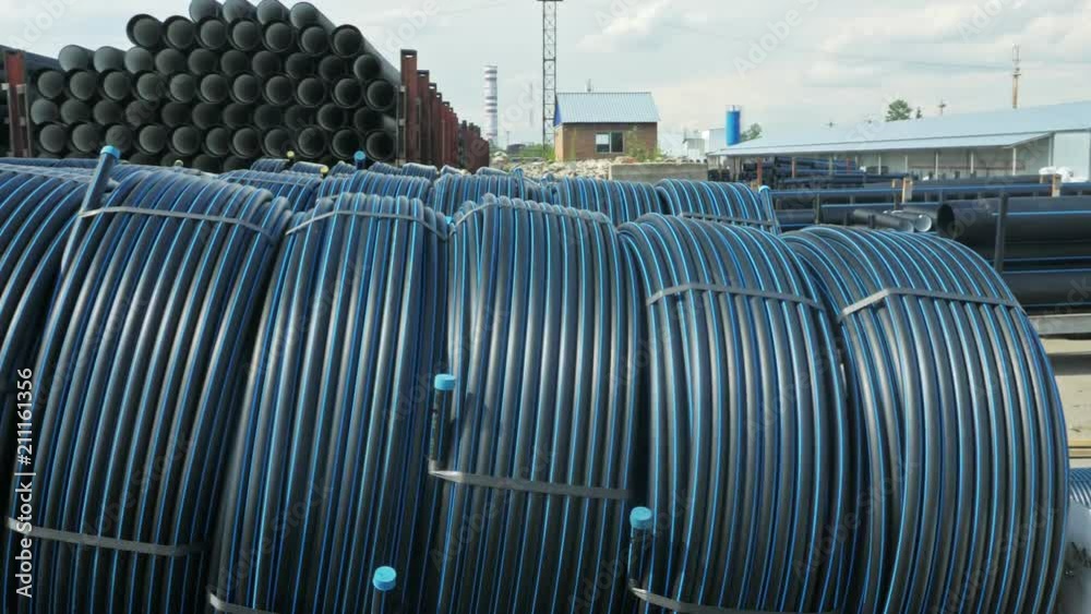 Warehouse of finished plastic pipes industrial outdoors storage site. Manufacture of plastic