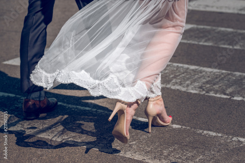 Married couple in wedding clothes holding hands