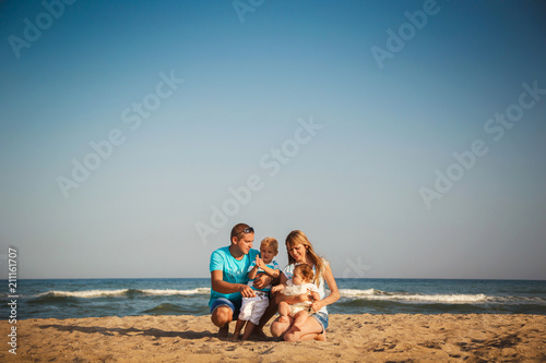 Young happy loving family with small kids having fun at beach together near the ocean  happy lifestyle family concept