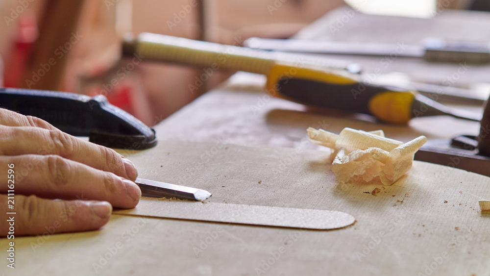 Marking and Pasting brace to the soundboard of a classical guitar. Production of classical guitar. Marking and Pasting brace to the soundboard of a classical guitar. Production of classical guitar.