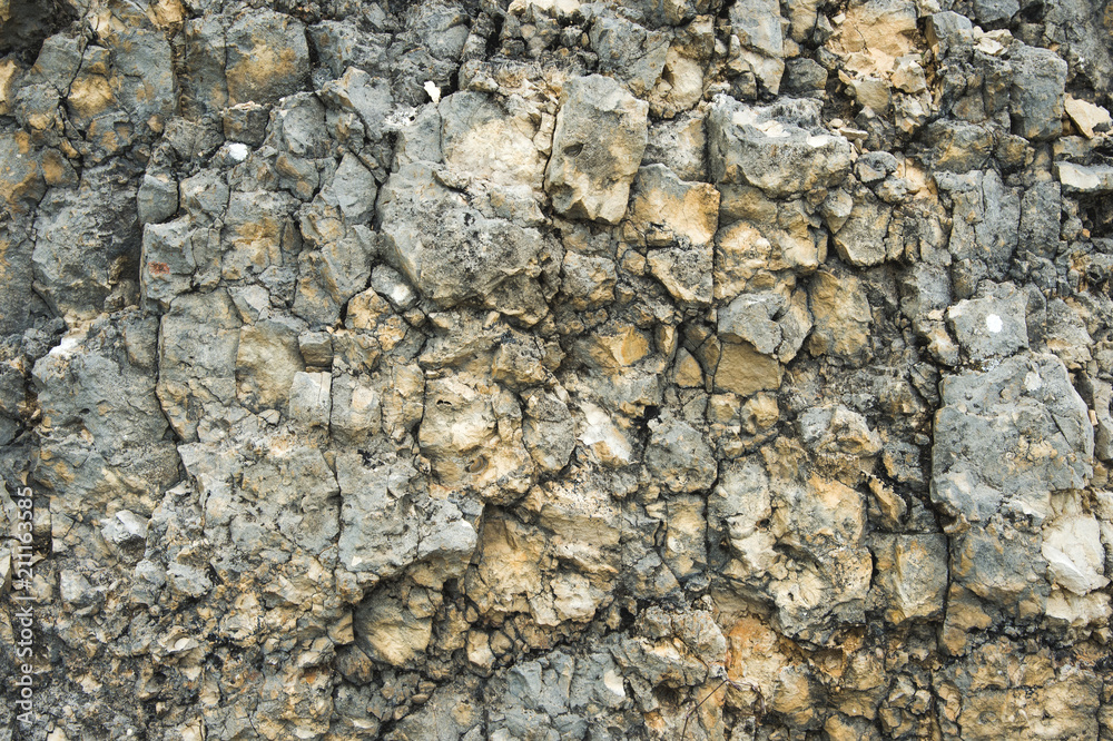 Textured stone background Rubble ballast in natural form in the rock wall Textured stone background Rubble ballast in natural form in the rock wall