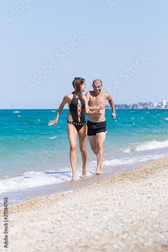 Attractive couple having fun on the beach