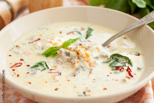Soup with sausages, spinach, vegetables and coconut milk