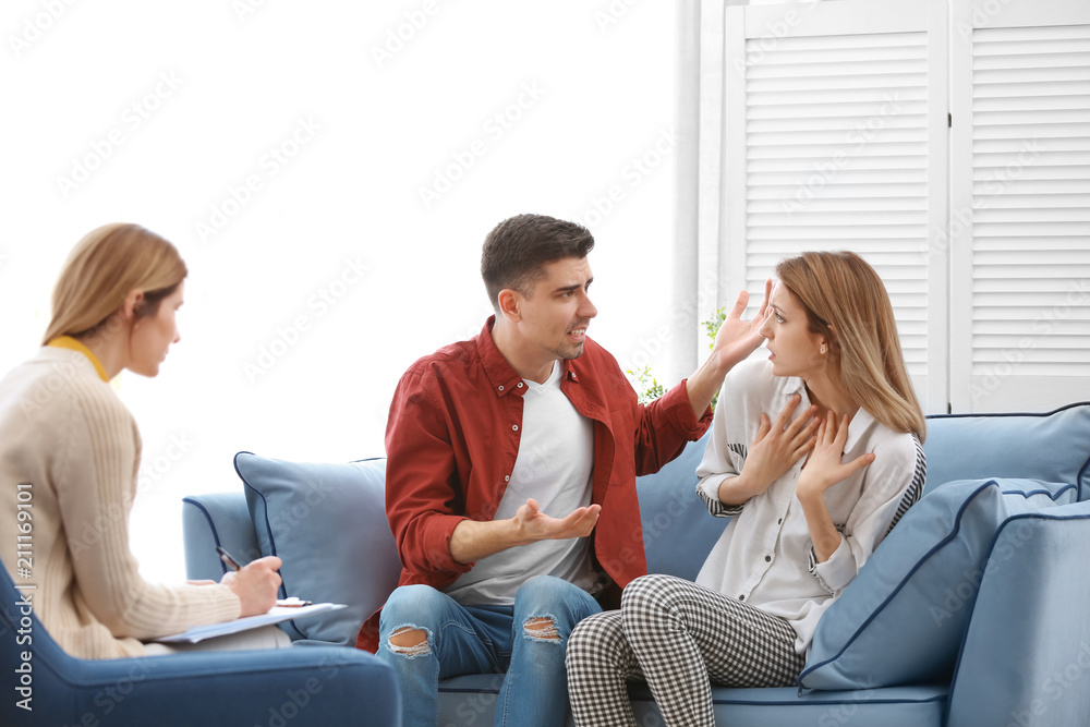 Young couple with problem at family psychologist office Young couple with problem at family psychologist office