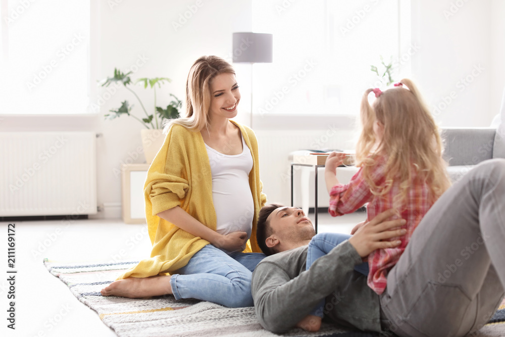 Young pregnant woman with her family at home Young pregnant woman with her family at home