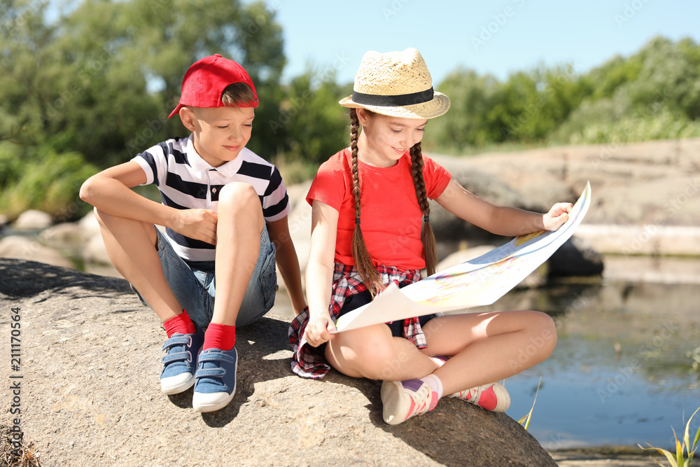 Little children with map outdoors. Summer camp