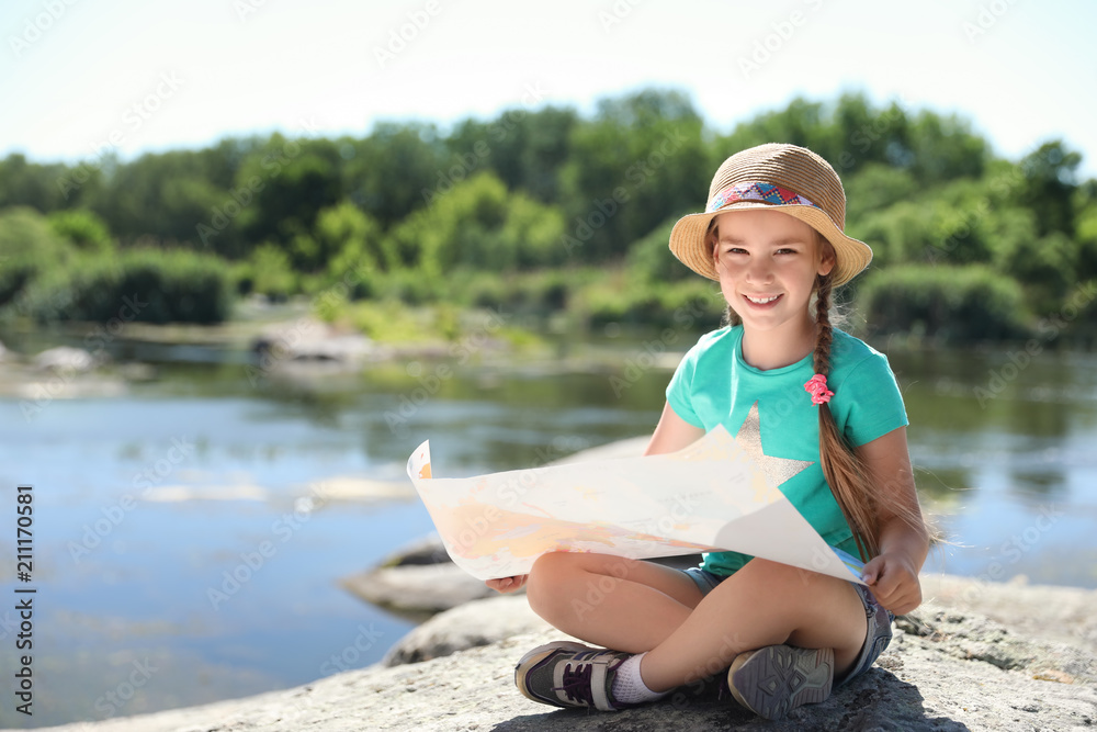 Little girl with map outdoors. Summer camp