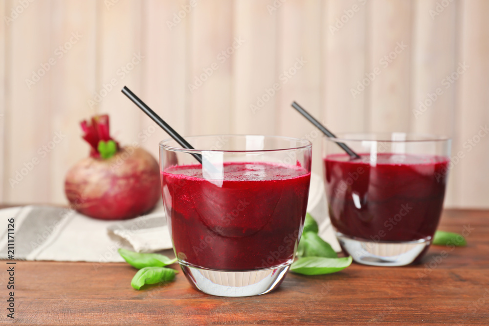Glasses of fresh beet juice on wooden table Glasses of fresh beet juice on wooden table