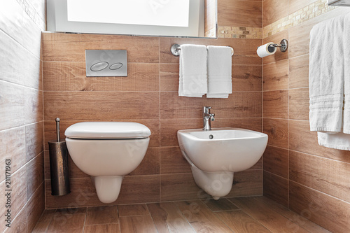 Bathroom interior. Closeup of Bidet and wc in simple but elegant italian style bathroom photo