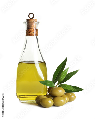 Glass bottle with fresh olive oil on white background