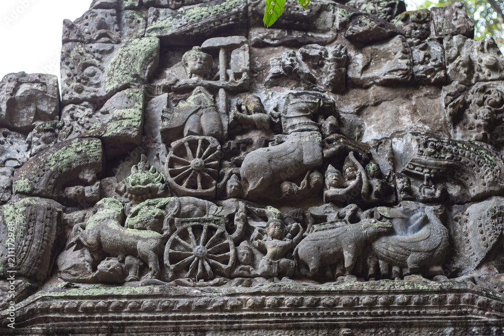 Ancient temple stone carved bas-relief in Angkor Wat. Hinduist god in carriage bas-relief closeup. Angkor Wat temple