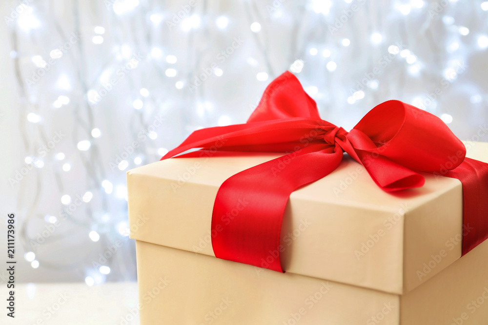 Beautiful Christmas gift on blurred background, closeup Beautiful Christmas gift on blurred background, closeup
