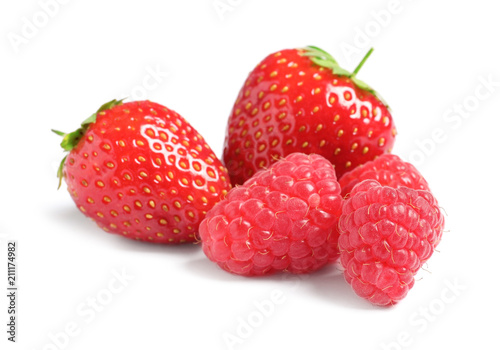 Raspberries and strawberries on white background