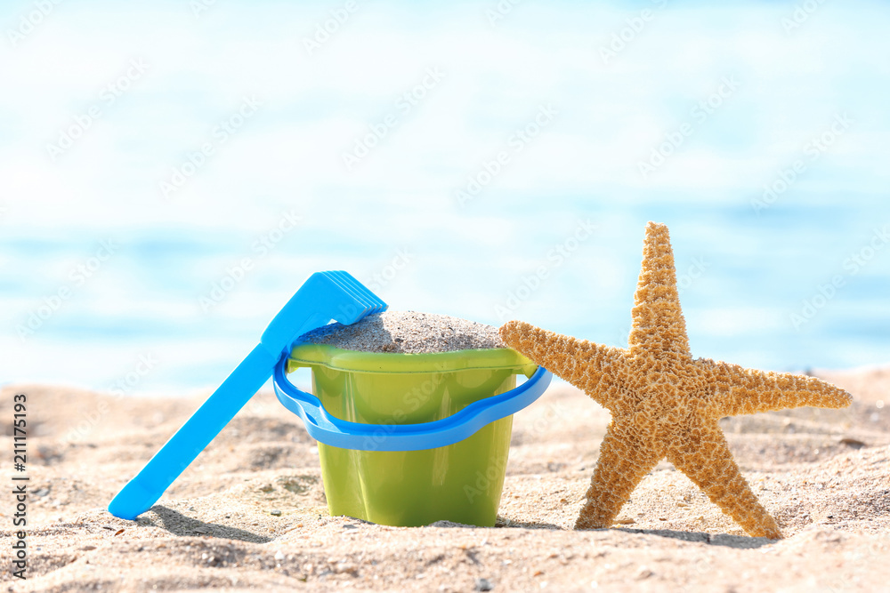Children toys on sand near sea. Beach object Children toys on sand near sea. Beach object