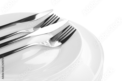 Stack of plates with forks and knife, closeup