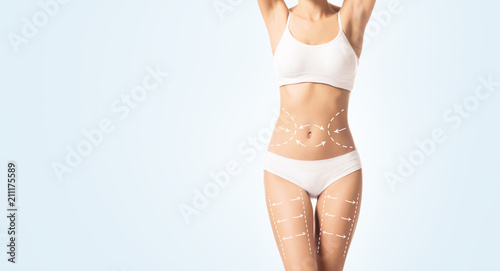 Beautiful female body. Weight loss, sports, exercising, water balance, healthy nutrition concept. photo