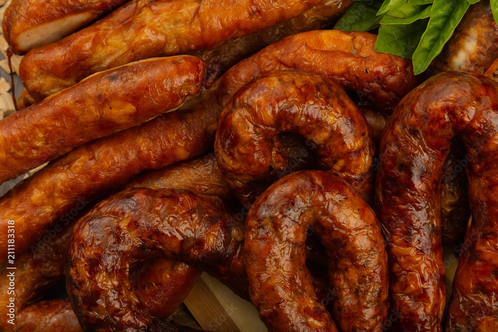 Homemade sausage on a wooden background with seasonings and sauce. Homemade sausage on a wooden background with seasonings and sauce.