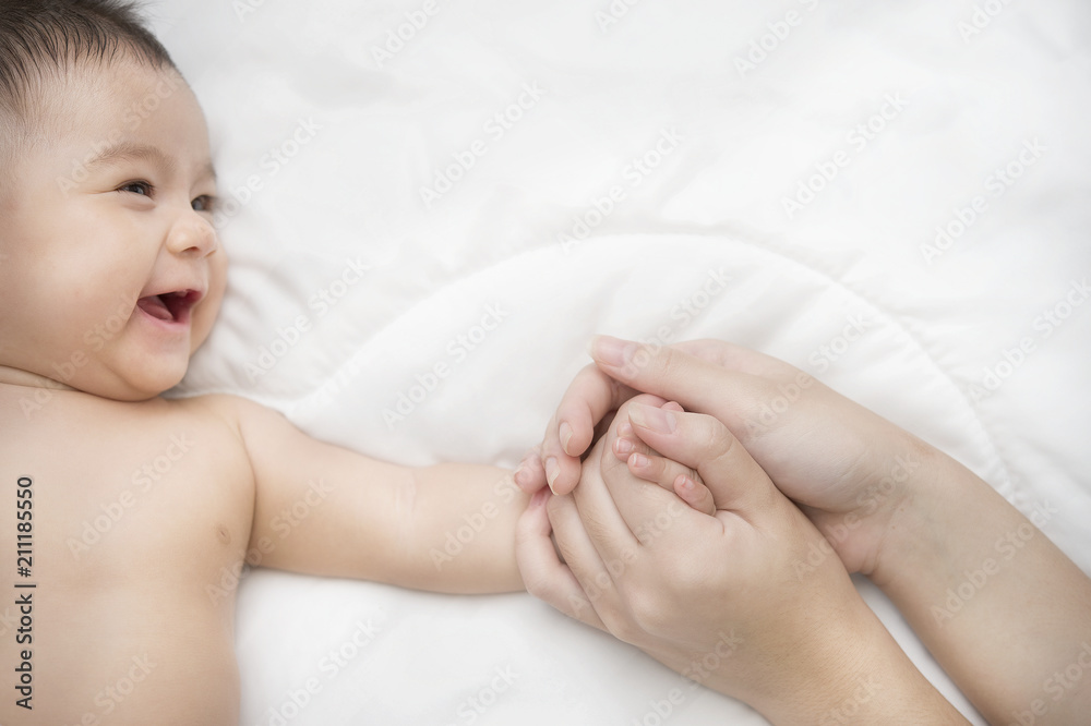 Smiling baby girl lying on a bed Smiling baby girl lying on a bed