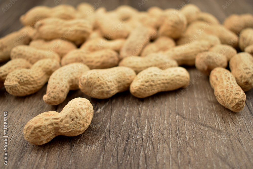 Peanuts on a wooden background stock photo images. Pile of peanuts with nutshell. Roasted Peanuts on a natural background Peanuts on a wooden background stock photo images. Pile of peanuts with nutshell. Roasted Peanuts on a natural background