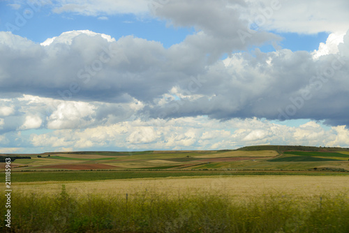 Rolling green hills with dramatic clouds in the agricultural heart of Spain  near Salamanca