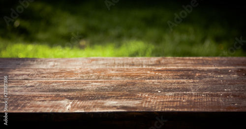 wooden picnic tabletop in the garden - summertime background with copy space