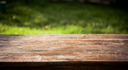 wooden picnic tabletop in the garden - summertime background with copy space