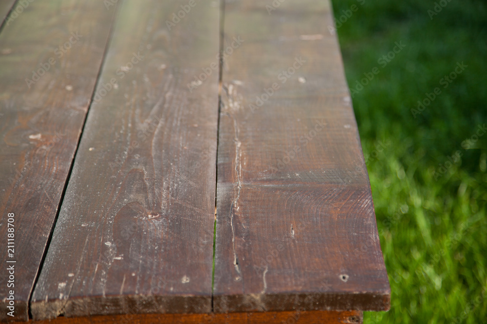 wooden picnic tabletop in the garden - summertime background with copy space wooden picnic tabletop in the garden - summertime background with copy space