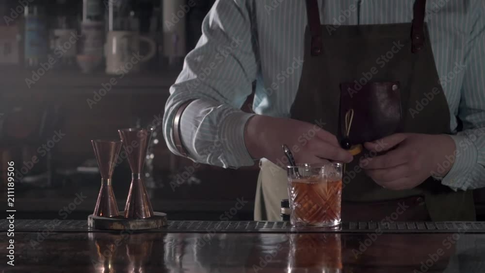 Bartender prepare Old fashion coctail in modern bar. Barmen stirring and pouring. Bartender prepare Old fashion coctail in modern bar. Barmen stirring and pouring.
