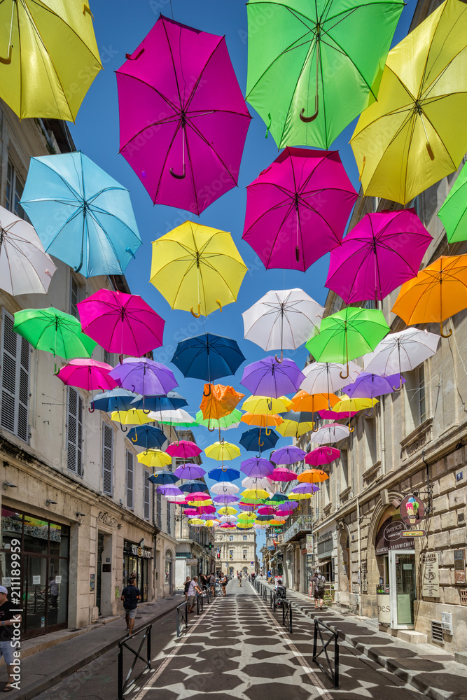 Multicoloured umbrellas as street art in Arles, France