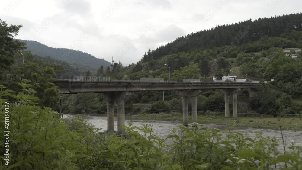 Bridge in Mountains river Timelapse in Caucasian Georgia nature with trees and clouds Bridge in Mountains river Timelapse in Caucasian Georgia nature with trees and clouds
