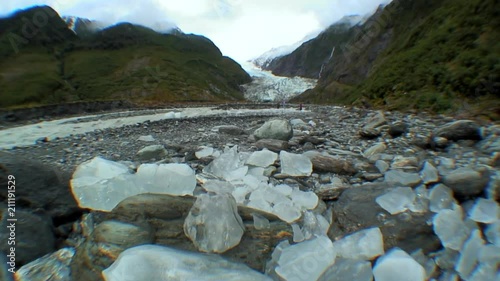 Chunks of Glacial Ice with a Glacier in the Background photo