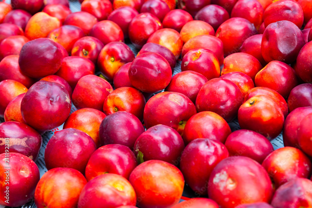 Fresh bright nectarines background in the market Fresh bright nectarines background in the market