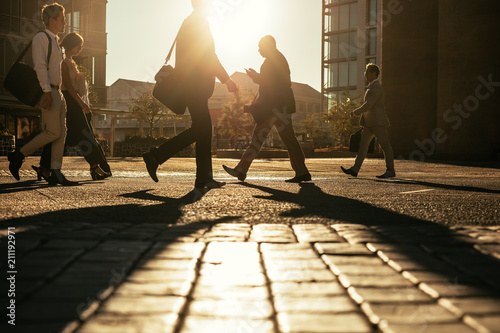 Business people walking to office early in the morning photo