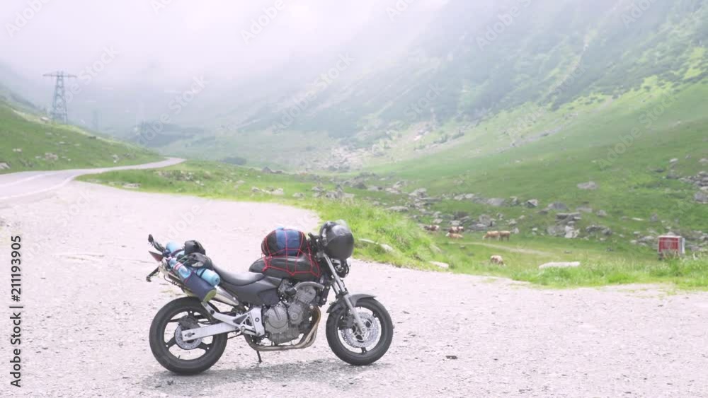 Motorcycle of traveler on the Transfagarasan highway in Romania, the most beautiful road in Europe Motorcycle of traveler on the Transfagarasan highway in Romania, the most beautiful road in Europe