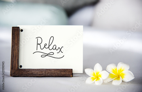 Card on a bed with plumeria flowers mockup