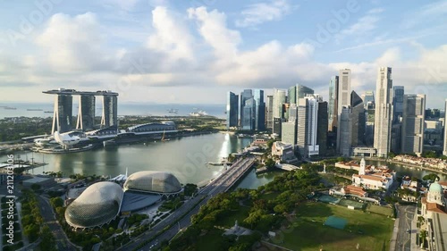 Rolling clouds time lapse over Marina Bay Singapore city skyline.  Tilt up