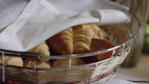 fresh croissants in the basket on the served table in buffet in the new hotel