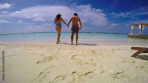 Slow Motion: Couple Walking into Stunning Water photo